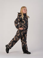 Luxury girls’ snowsuit with golden baroque print on black, handcrafted in Europe from waterproof polyester with Sorona® plant-based insulation. Warm and breathable winter overall for kids, certified Oeko-Tex Standard 100, perfect for skiing and cold weather up to −25°C.
