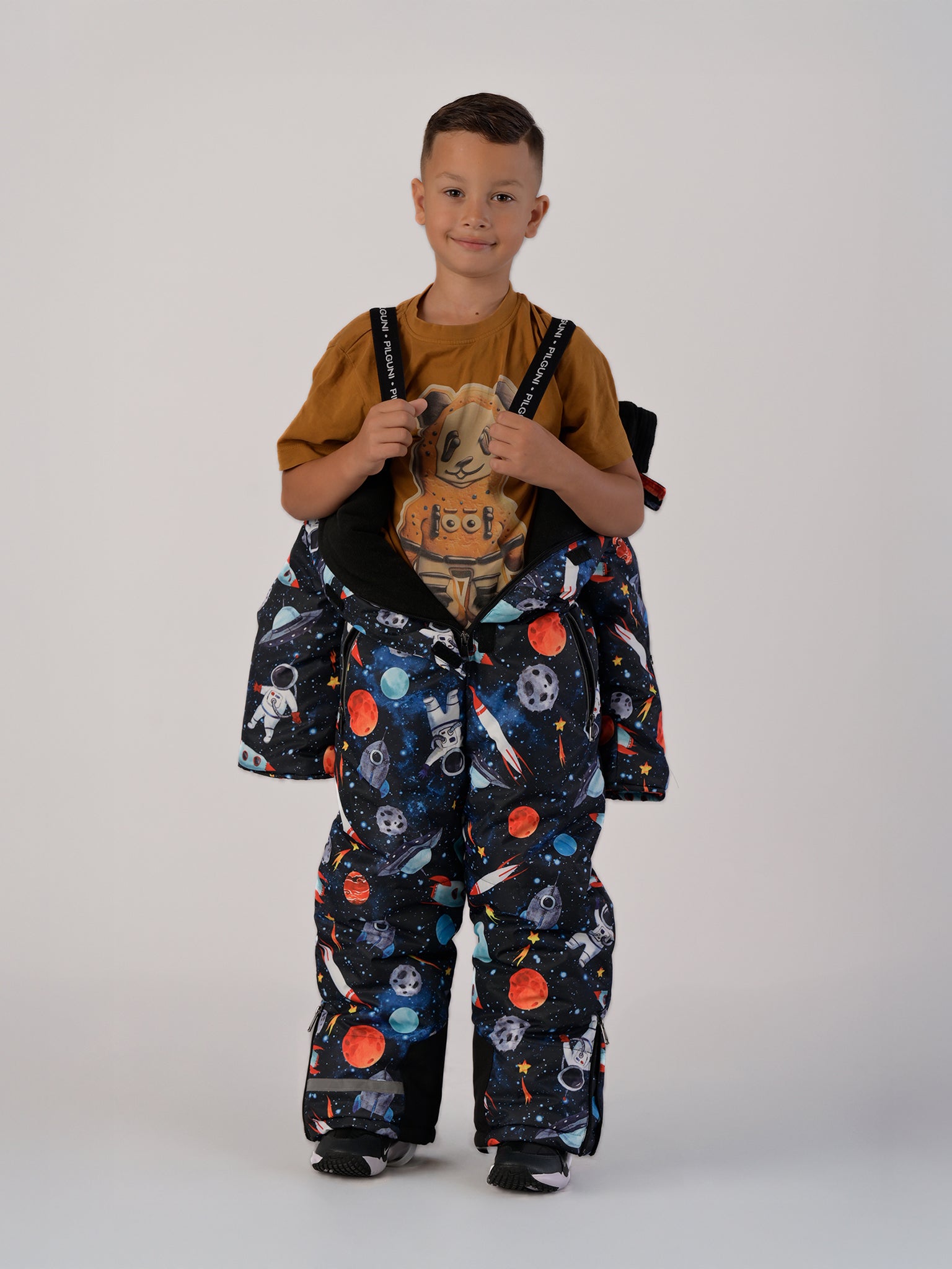 Luxury kids’ snowsuit with cosmic space print featuring rockets and planets, waterproof and breathable, Sorona® eco insulation, Oeko-Tex certified, handcrafted in Europe for warmth to −25°C.